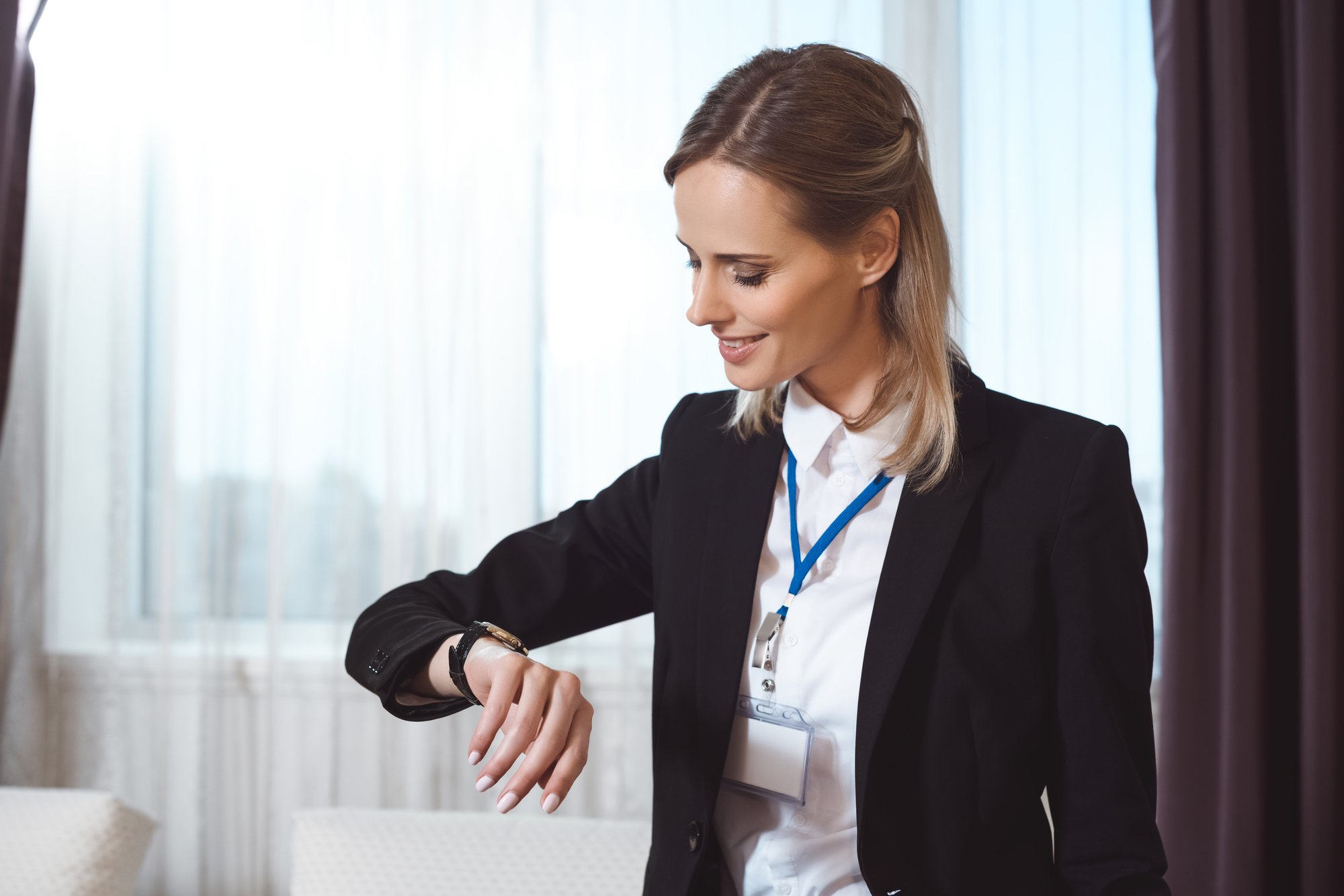 hotel staff checking smartwatch notification