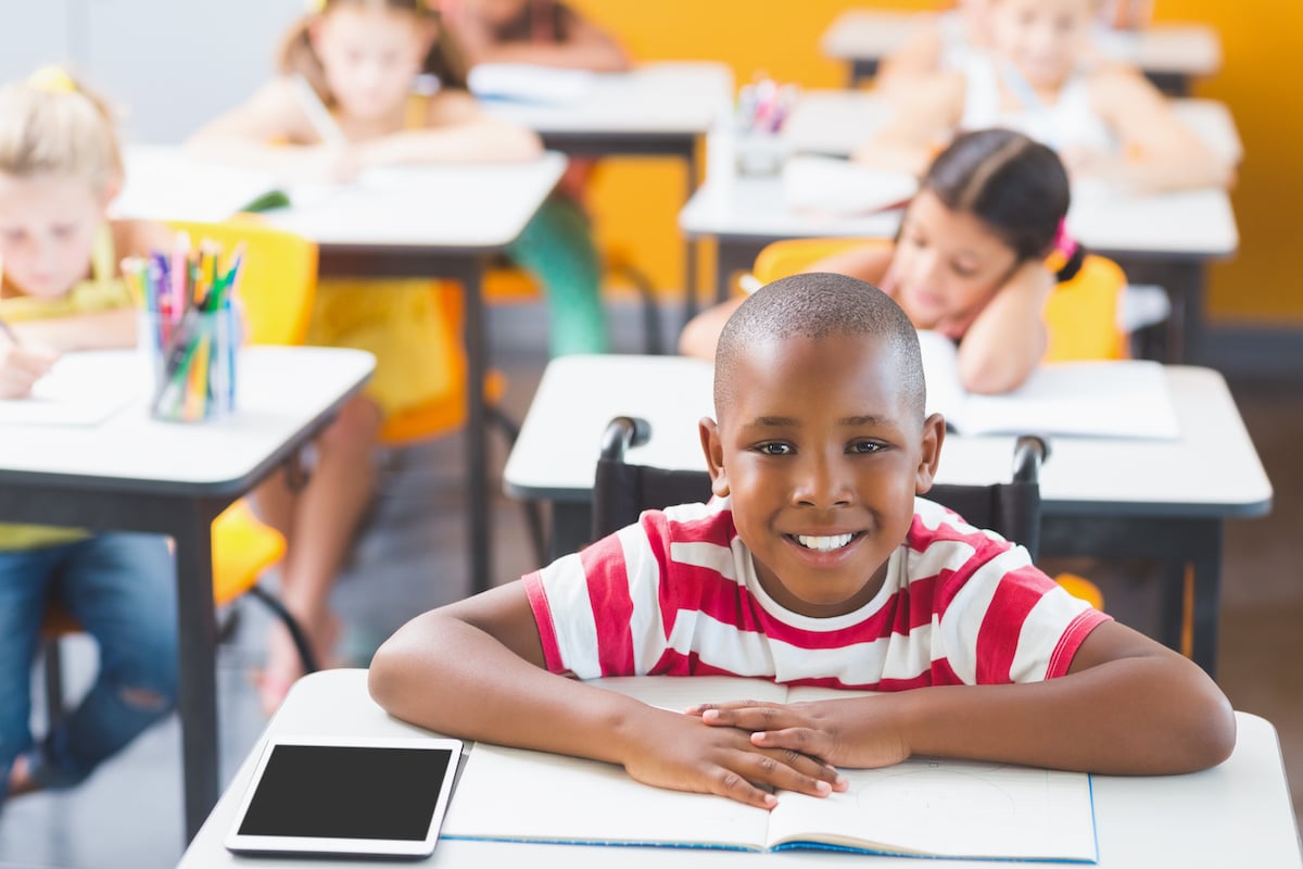 disabled-schoolboy-smiling-in-classroom-2021-08-28-18-32-42-utc
