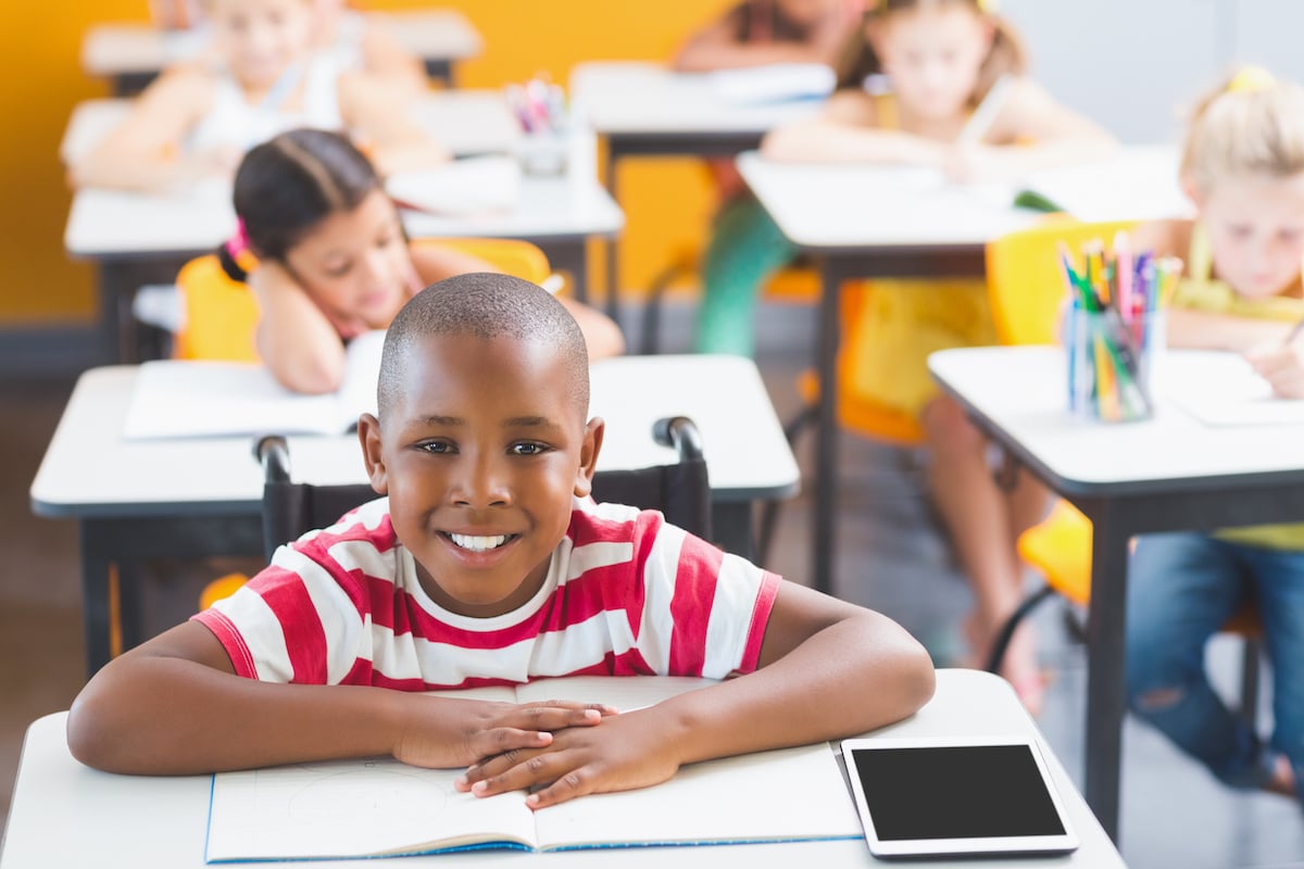 school boy smiling in the classroom