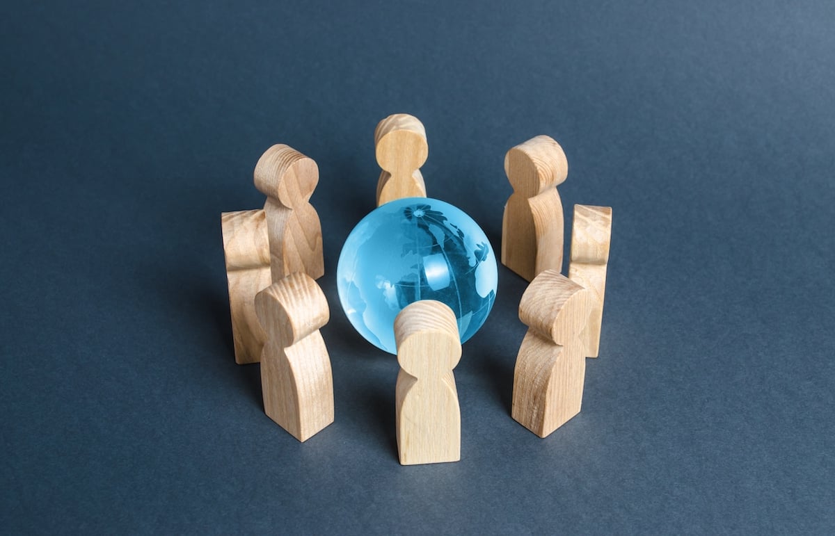 people-surrounded-a-blue-glass-globe-2021-08-30-18-08-44-utc