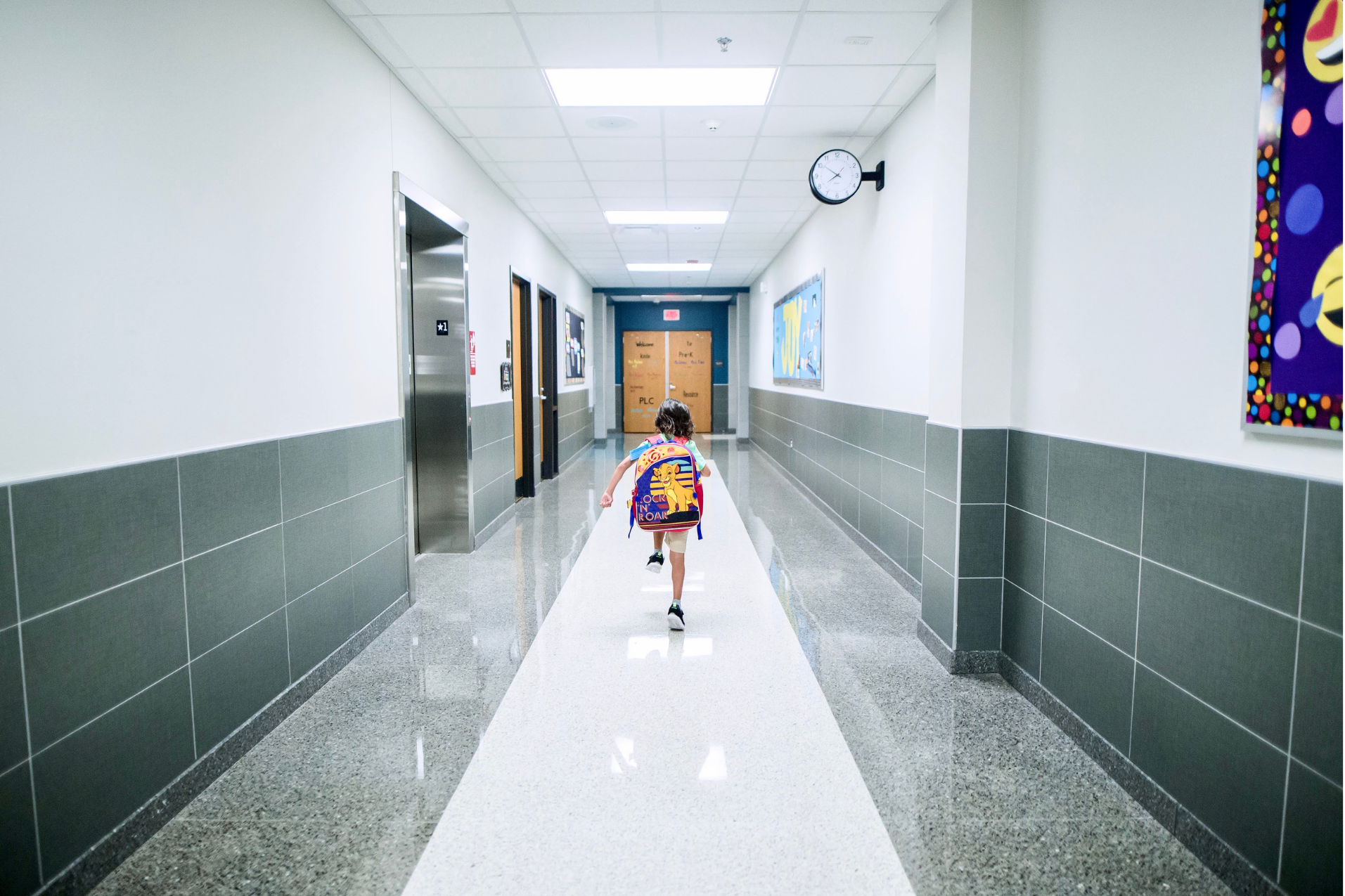 student running in school hallway