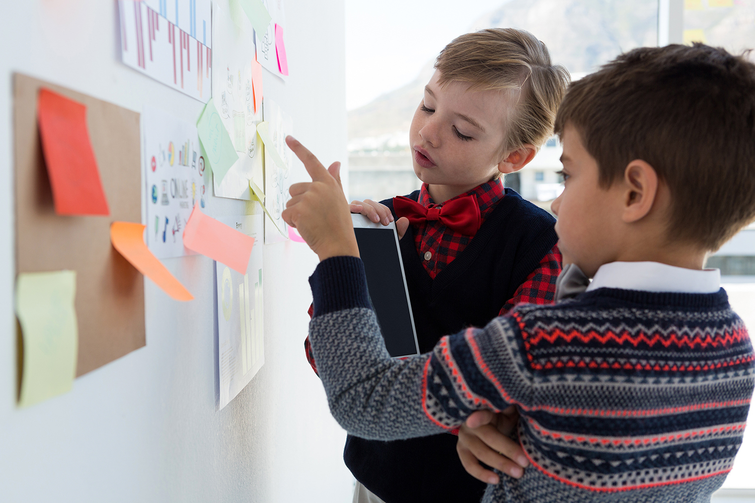 two boys looking at whiteboard