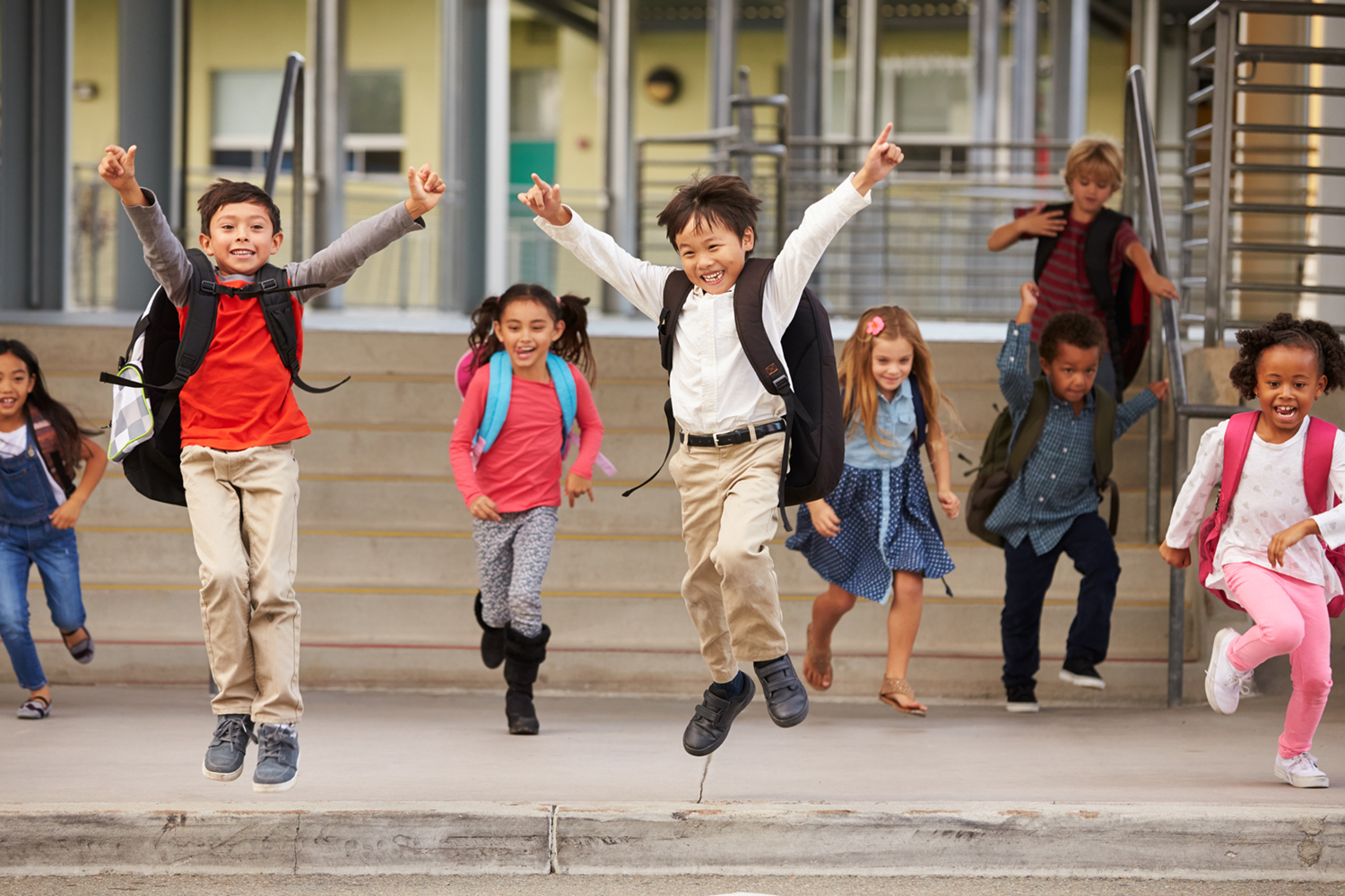 happy kids jumping at school