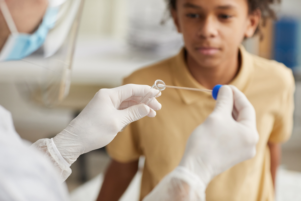 boy taking a covid test