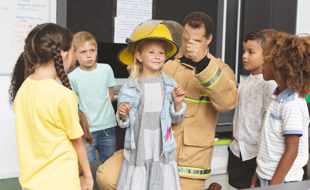 firefighter teaching school kids