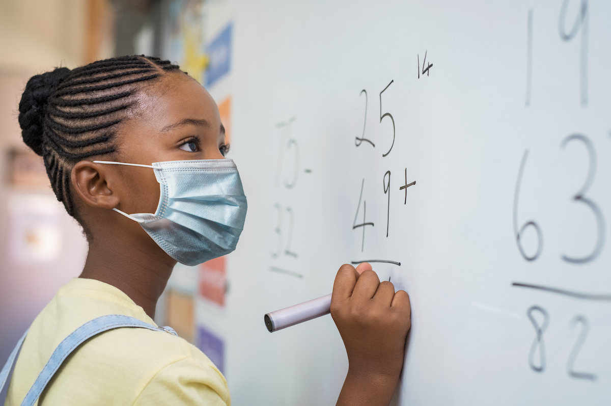 elementary girl wearing a mask at school