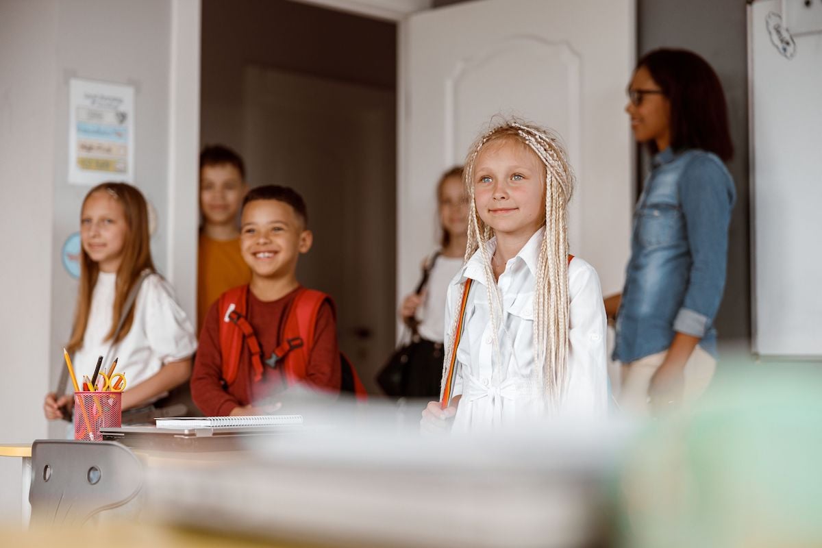 happy children standing in class at school