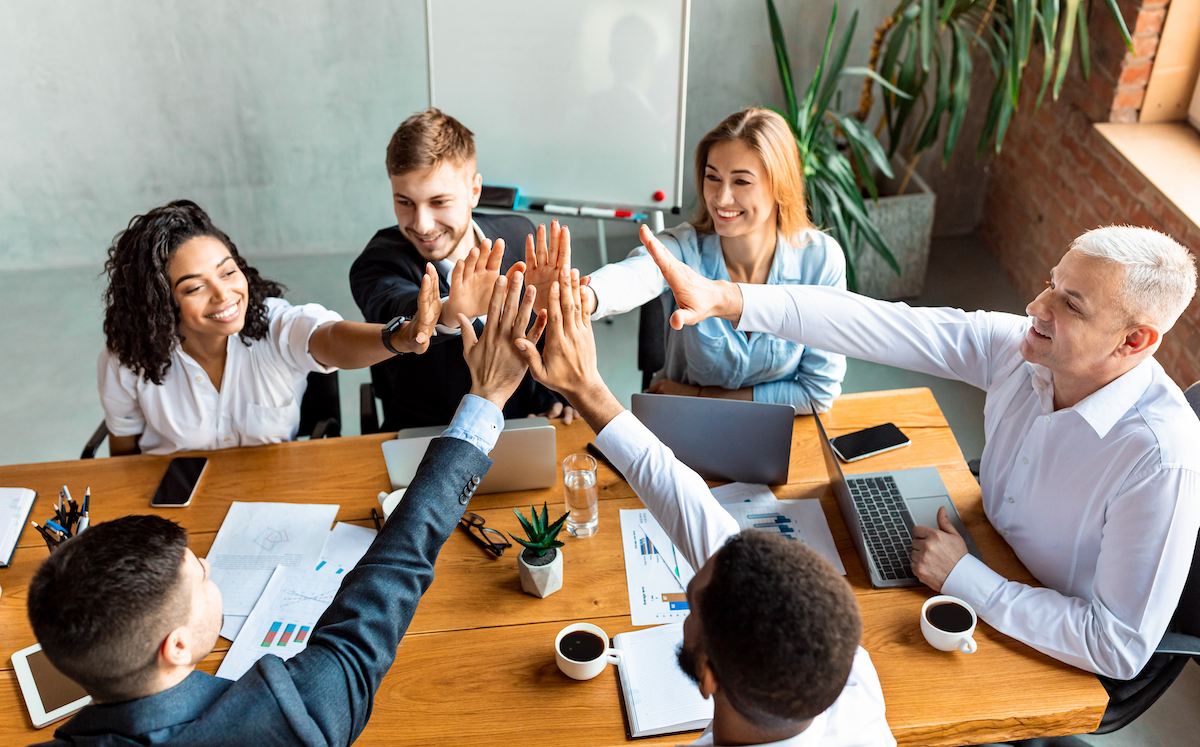 happy coworkers giving high five