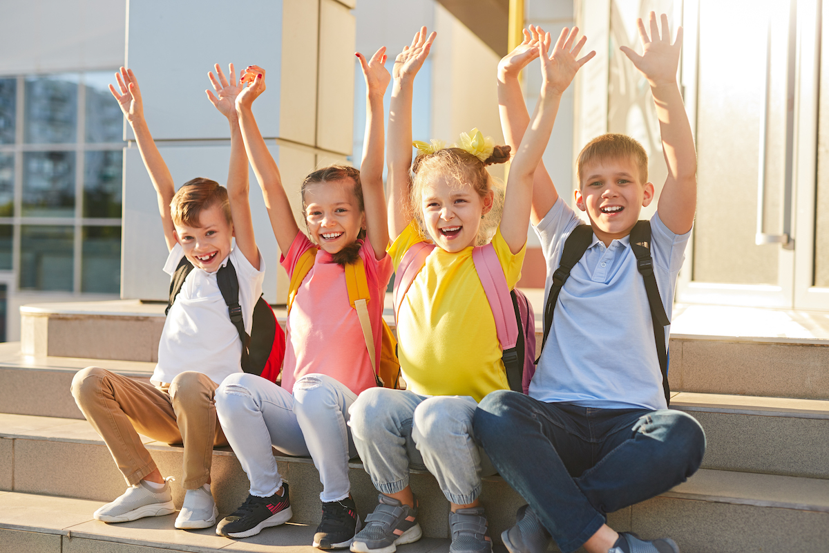 kids sitting on school steps