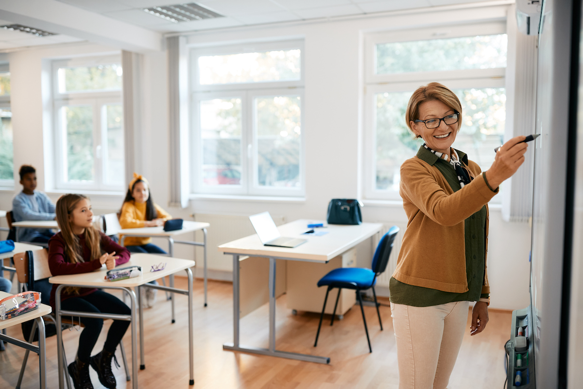 teacher giving a lesson to her class