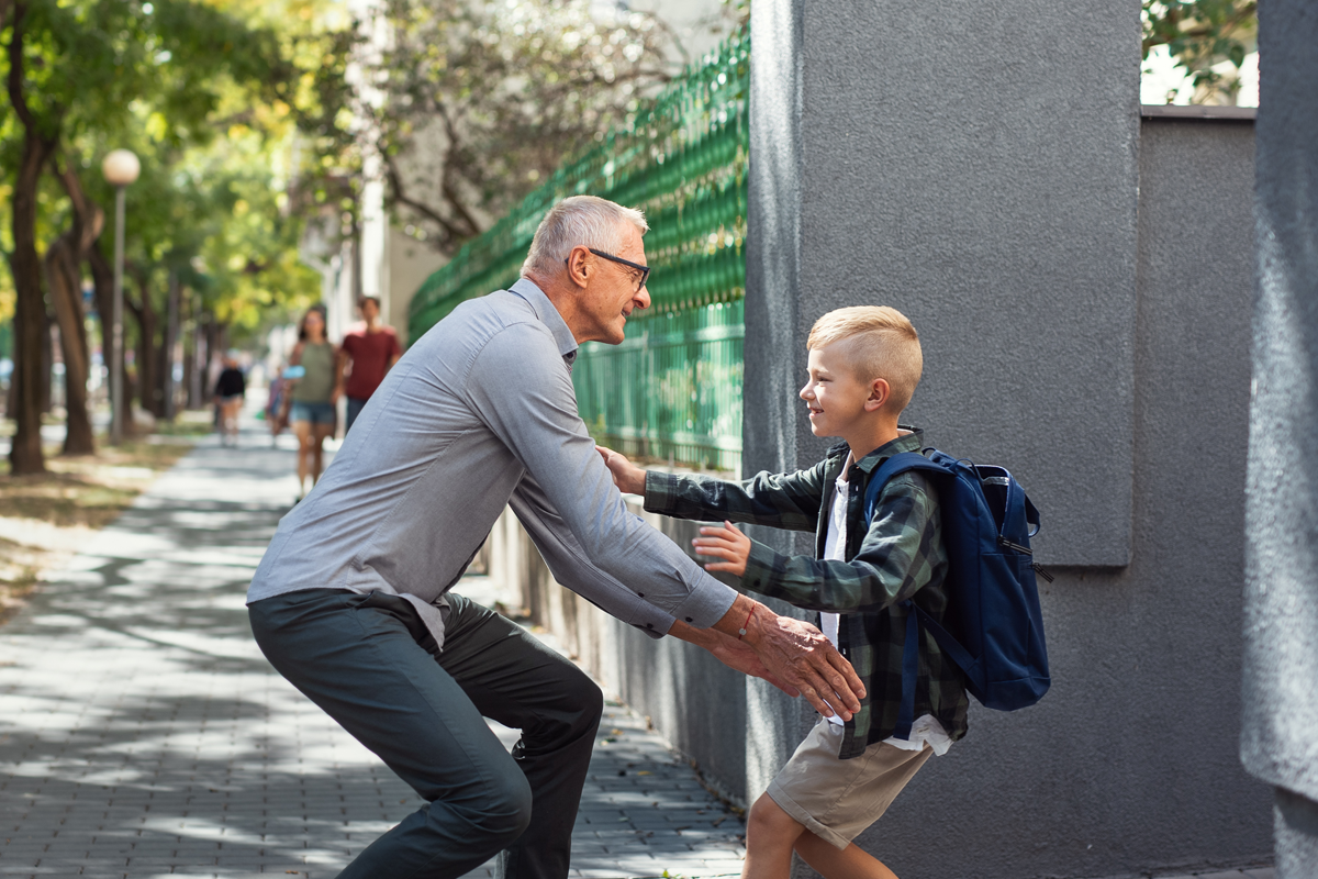 school boy running to his grandfather