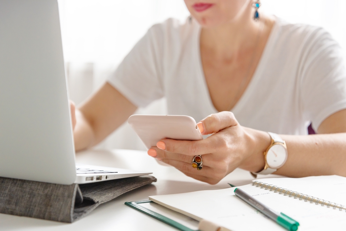 woman on phone and laptop