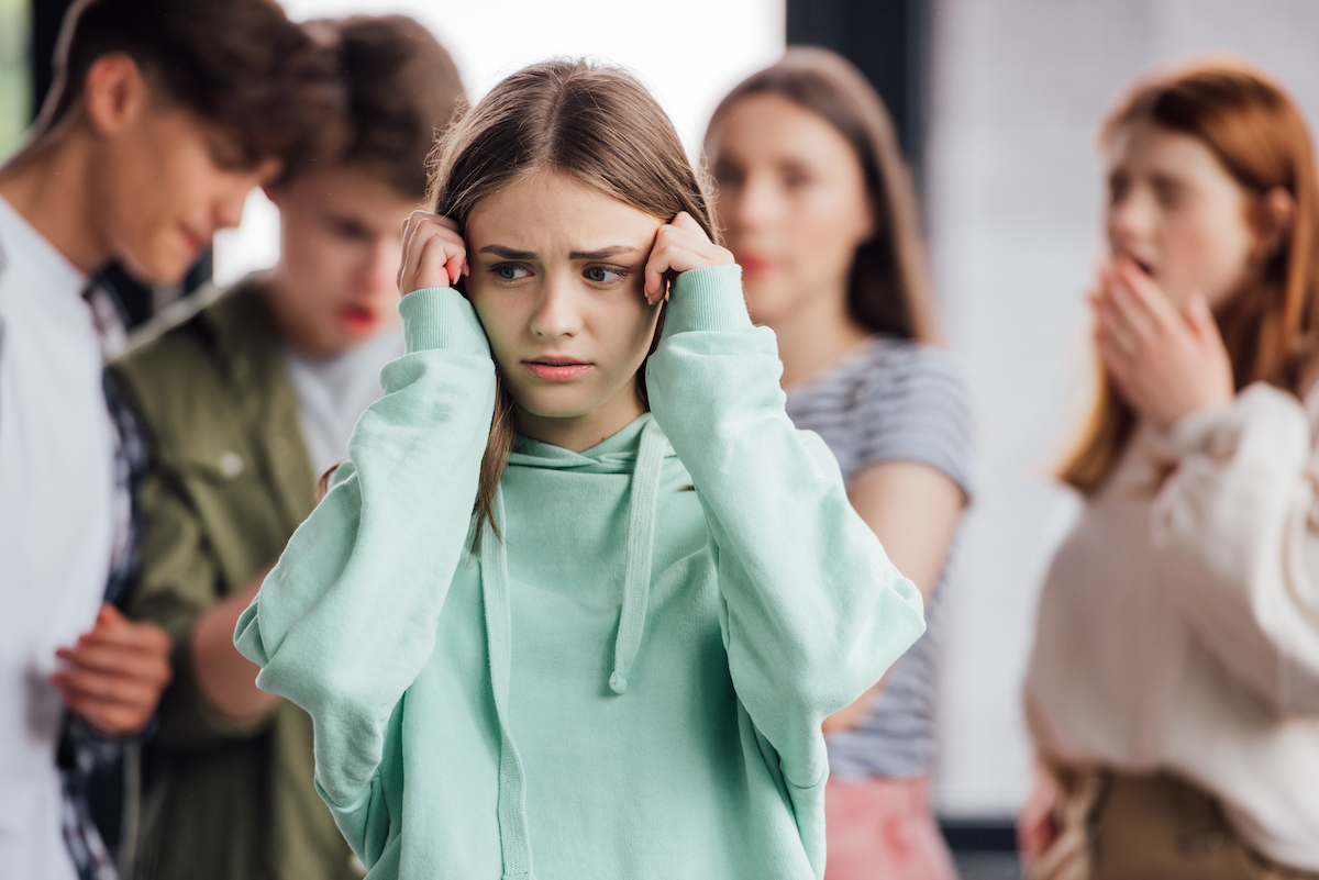 group of teenagers bullying a girl