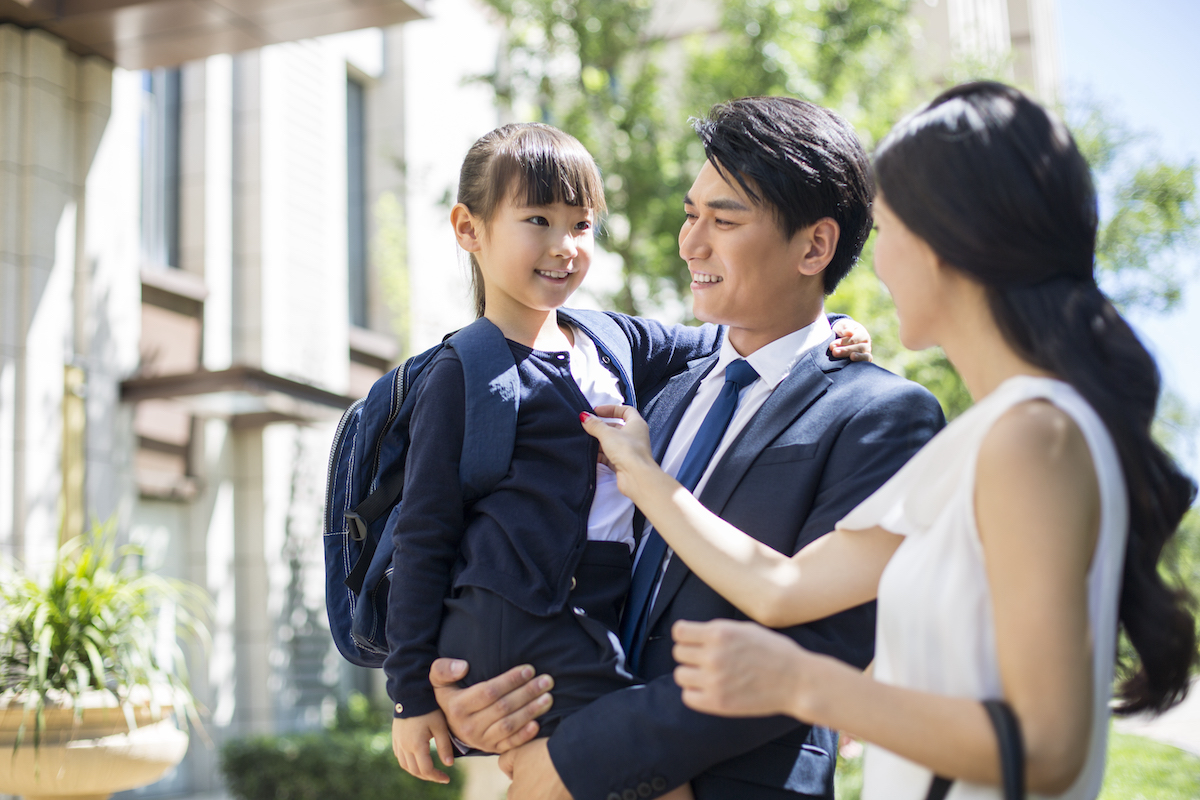 parents taking their child to school