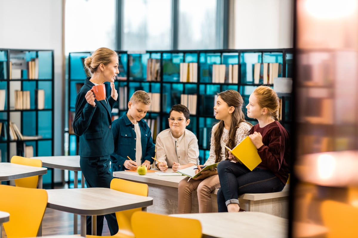 students in the library with a teacher