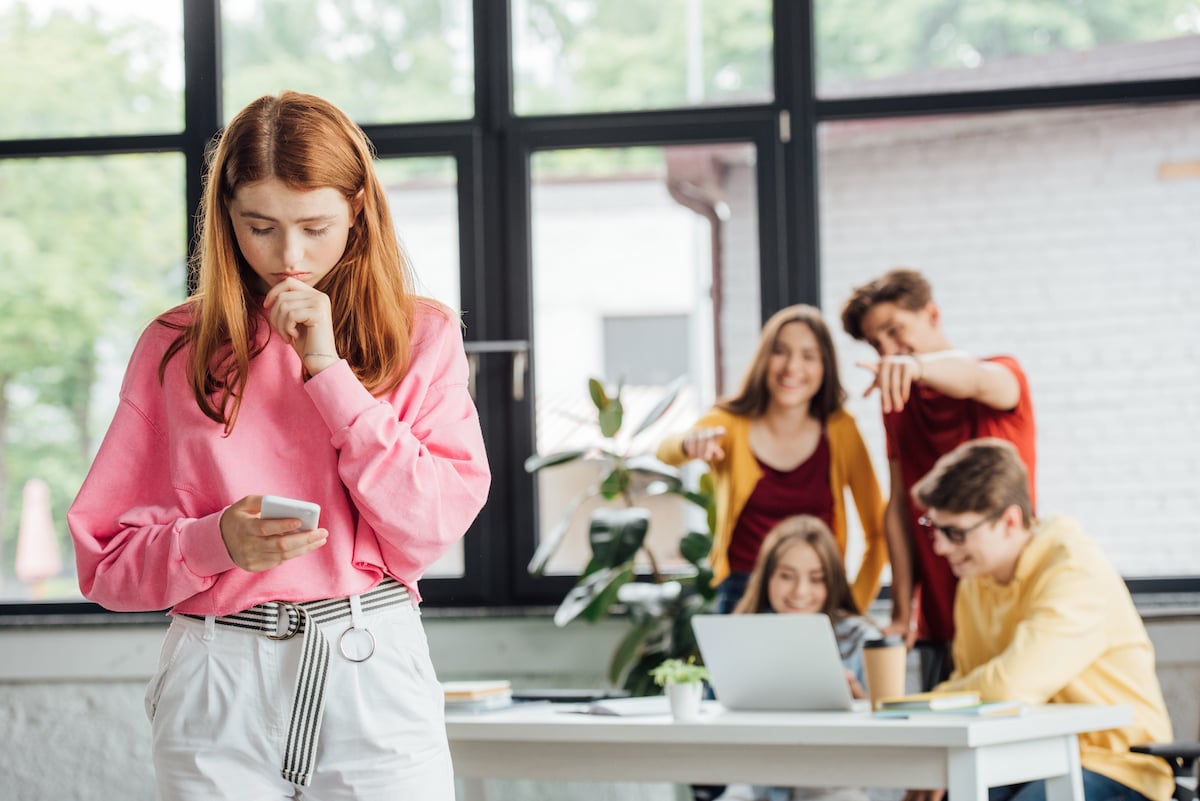 group of students bullying a girl