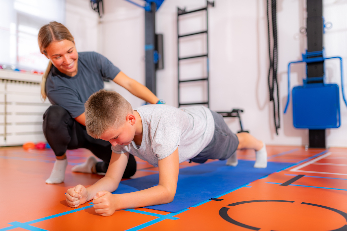 child in gym class doing a plank