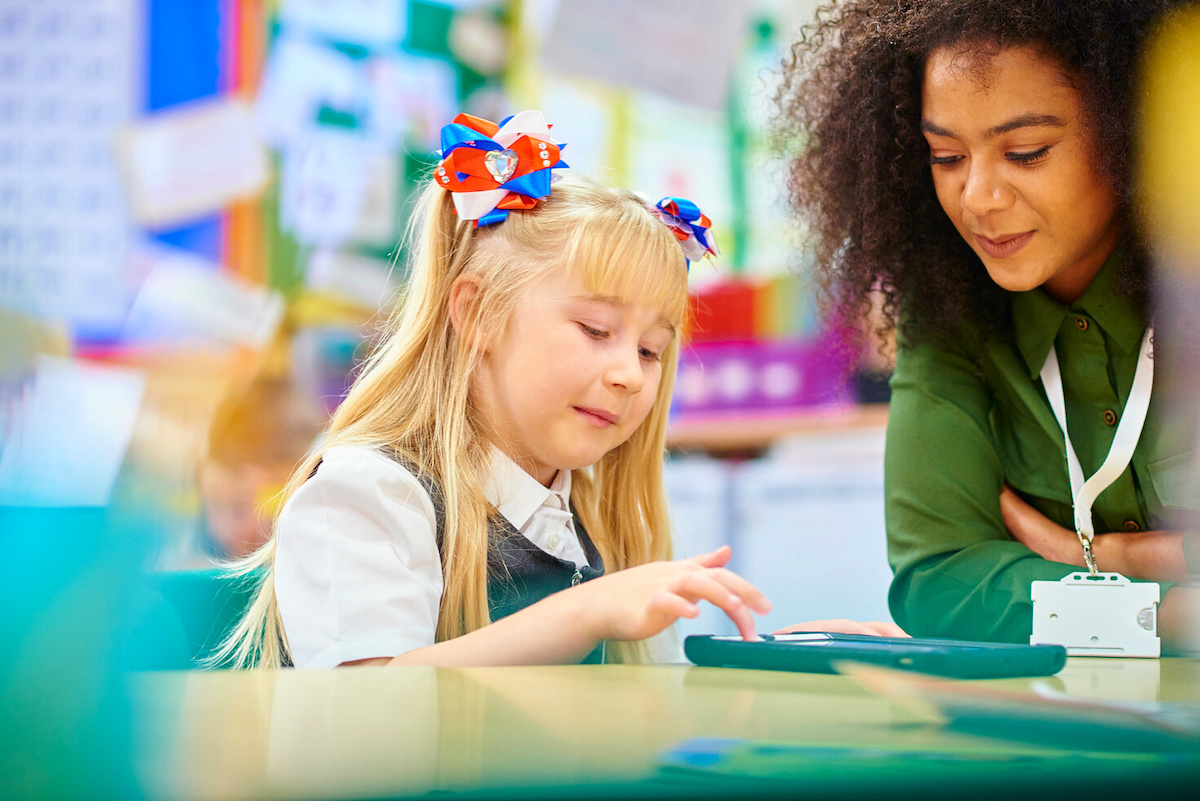 teacher and student using a tablet together