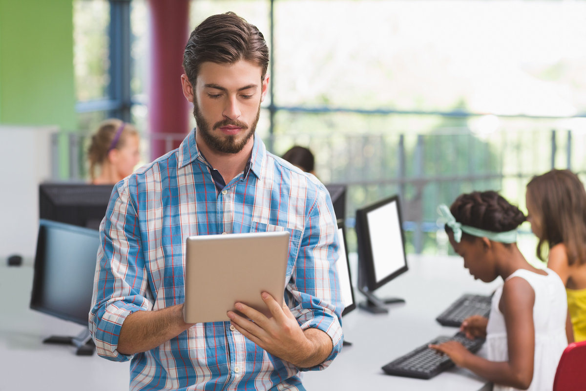 teacher using a tablet in the classroom