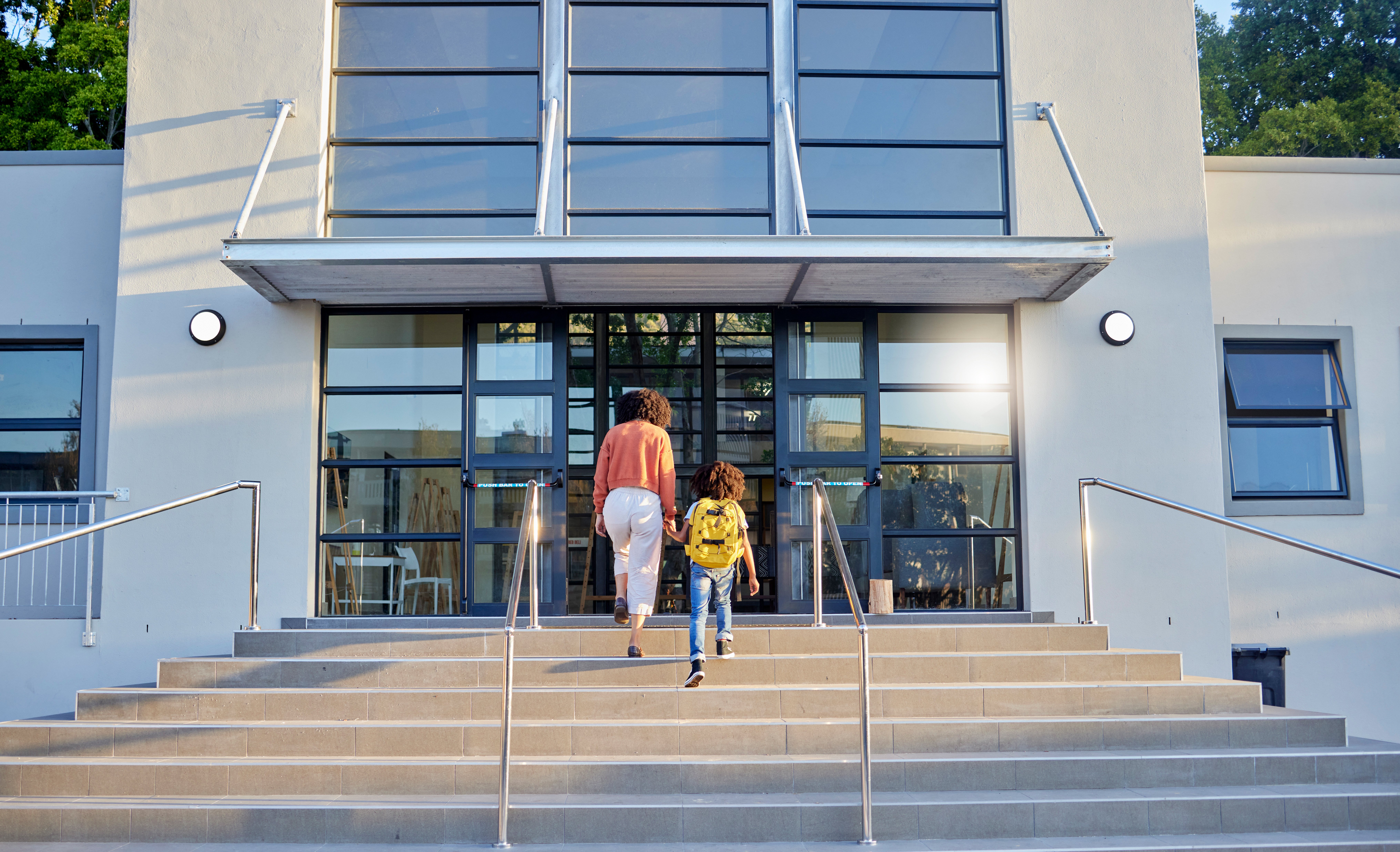 parent and child walking into school